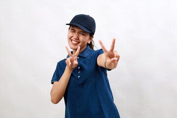 Young hispanic woman courier wearing delivery uniform and cap smiling looking to the camera showing fingers doing victory sign. number two.