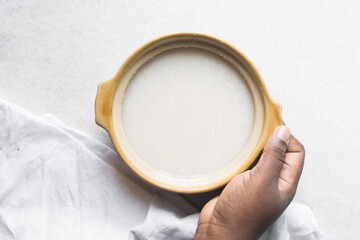 Overhead view of Plain rice congee in a clay pot, top view of rice porridge, chinese congee, korean...