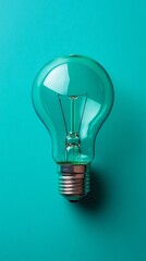 Light bulb on teal background, concept of innovation