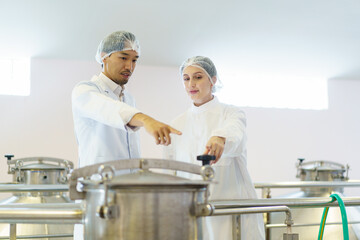 Quality control officer are examining in beverage manufacturing factory.