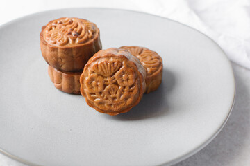 homemade mooncakes on a grey plate, top view of baked mooncakes on a plate, process of making mooncakes for Lunar New Year and mid autumn festival