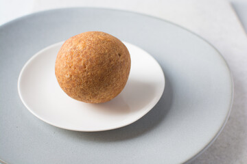homemade nigerian egg roll on a white background, freshly made african egg roll on a white plate, egg wrapped in fried dough