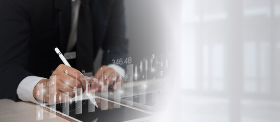 Businessperson using a digital pen on a tablet with financial graphs and data overlay, representing market analysis and financial investment growth.