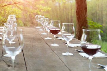 wine glasses on a wooden table in the countryside