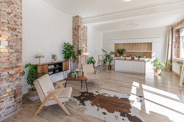 Bright and spacious living area featuring modern furniture and natural light in a stylish apartment in soft warm colors