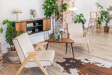 Bright and spacious living area featuring modern furniture and natural light in a stylish apartment in soft warm colors