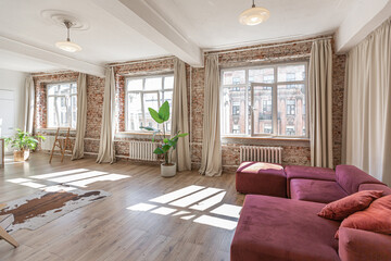Bright and spacious living area featuring modern furniture and natural light in a stylish apartment in soft warm colors