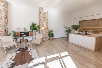 Bright and spacious living area featuring modern furniture and natural light in a stylish apartment in soft warm colors