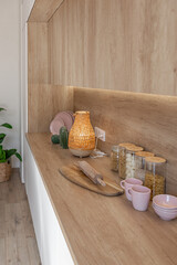 Bright and spacious living area featuring modern furniture and natural light in a stylish apartment in soft warm colors