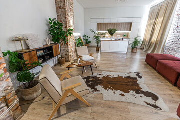 Bright and spacious living area featuring modern furniture and natural light in a stylish apartment in soft warm colors