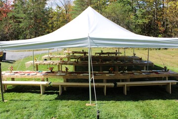 Outdoor Event Tent with Rustic Wooden Tables and Place Settings