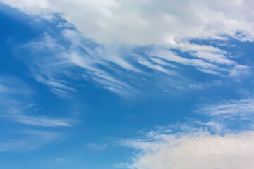 Cloudy blue sky background with white fluffy clouds, ideal for nature wallpapers and atmospheric designs