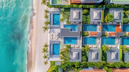 A stunning aerial view of luxury villas by the beach, featuring private pools, lush landscaping, and proximity to the ocean.