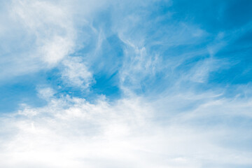 Obraz premium Beautiful cirrus clouds in the dark blue sky. Bright sunlight with soft clouds. Clear midday scene in the air at amazing weather