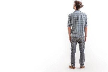 Naklejka premium Young man looking up with hands in pockets isolated on white.