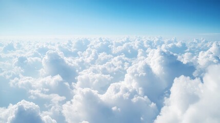 A serene view of fluffy white cloud against a bright blue sky, evoking tranquility and openness.