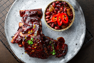 Roasted Pork Ribs in BBQ Sauce with Red Beans in the plate top view