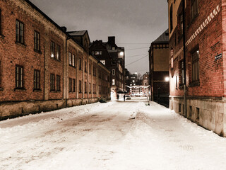 Picture of brick architecture Goteborg downtown at night in winter, snow lying on the street