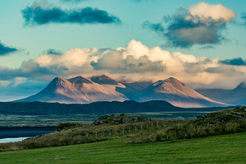 Naklejka premium Icelandic countryside with gorgeous mountain peaks colored by the setting summer sun. Travel in Iceland, EU