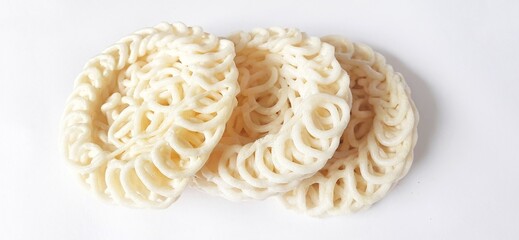 White noodle crackers or kerupuk putih or kerupuk warung made from tapioca flour, snack food from Indonesia isolated on white background