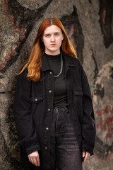 Studio portrait of a young beautiful red-haired girl.