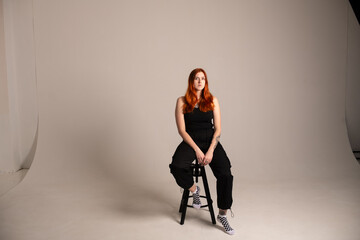 Studio portrait of a young beautiful red-haired girl.