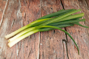 fresh green onions on rustic wood