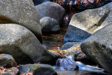 a brook  cascading through  the rocky terrain