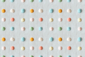 Polka dots seamless pattern. Textured embroidery on white linen with embroidered polka dots in soft...