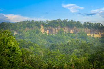 Green hills under blue sky. Beautiful landscape with blue sky. Aerial view of a beautiful hilly landscape in Bandarban, Bangladesh.