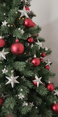 Decorated Christmas tree with red balls and silver stars, merry, ornament