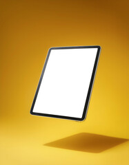 Tablet with white screen floating or flying isolated on yellow pastel background
