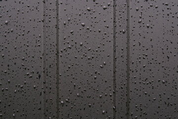 water drops on black metal surface background