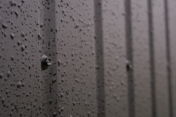 water drops on black metal surface background