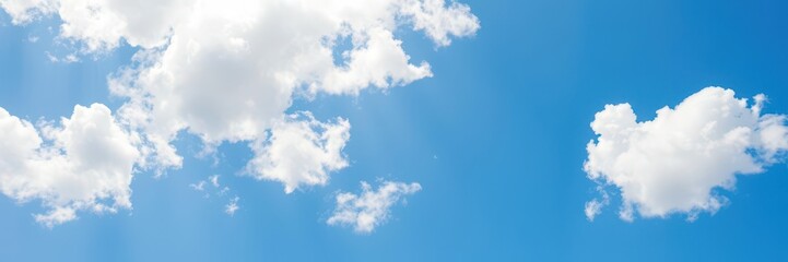Obraz premium Fluffy white clouds floating in a bright blue summer sky, outdoors, clouds