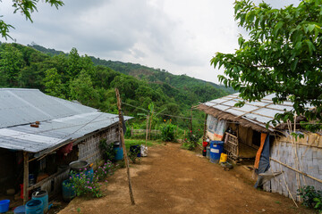 Obraz premium Adivasi homesteads on either side of the Bandarban hilly road. Tribal accommodation. 