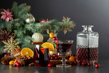 Christmas drinks with ingredients on a background of Christmas tree.
