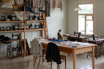 Interior with sewing accessories. Antique sewing machines, clothes for viewing