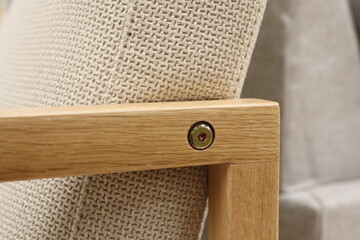 A Beautifully Stylish Wooden Armchair Detail Featuring a Soft and Comfortable Cushion