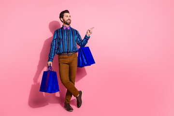 Full length photo of attractive elegant man wear stylish striped clothes look empty space isolated...