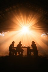 Silhouettes of people sitting at a table under a bright light in the night