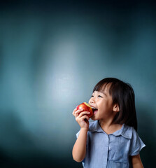 asian kid biting into an apple