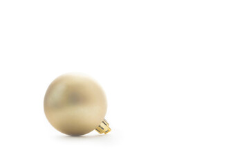 Close up of a golden Christmas ball isolated on white background, with text space.