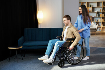 A young pretty girl helps her friend who is confined to a wheelchair