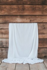Blank white cloth hanging on rustic wooden wall background