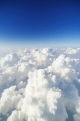 Breathtaking view of fluffy white clouds against a deep blue sky
