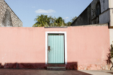 pastel blue door on pink wall in mexico
