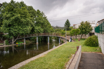 Landscape of Mosteiro river beach with lawn, trees and footbridge, Pedrogão Grande PORTUGAL