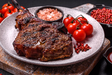 Grilled wagyu beef tomahawk steak with salt, spices and herbs