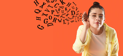 Young gossip woman trying to hear something on orange background, closeup